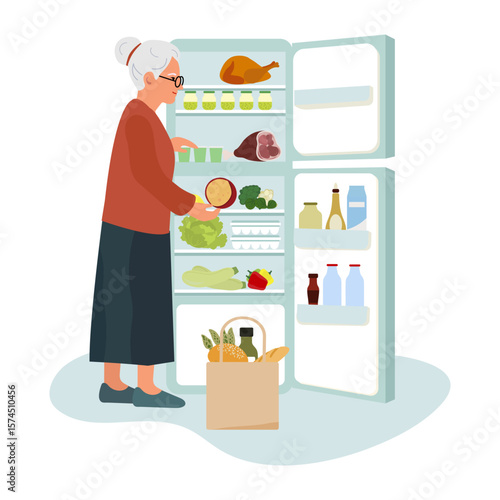 Elderly woman organizing groceries in open refrigerator with fresh produce and drinks