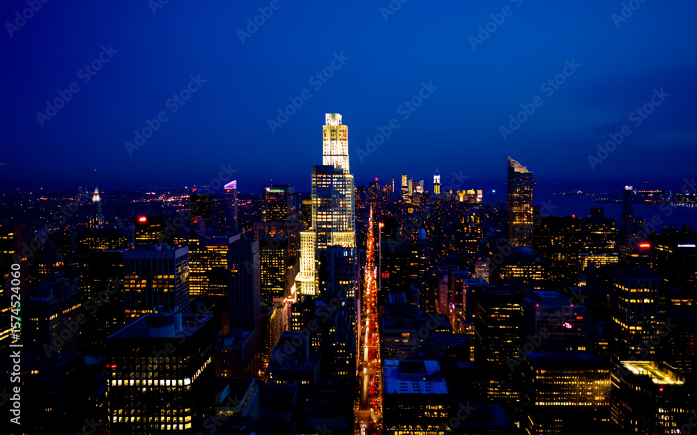 Fototapeta premium USA, New York City, New York, Manhattan, Aerial view of illuminated skyline at night.