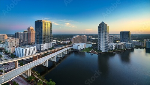 aerial view of abstract buildings and a bridge with traffic over a river in downtown tampa florida united states
