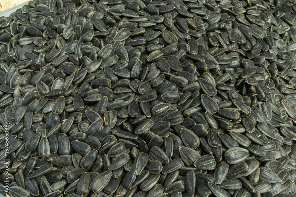 Closeup of sunflower seeds. The intricate beauty and potential of sunflower seeds. Sales of sunflower seeds in the market. A detailed view of fresh sunflower seeds ready for planting. Closeup of sunflower seeds. The intricate beauty and potential of sunflower seeds. Sales of sunflower seeds in the market. A detailed view of fresh sunflower seeds ready for planting.