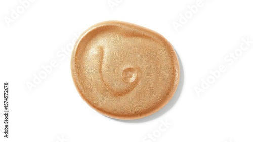 Close up shot of a shimmery tan and bronze cosmetic cream, providing a textured surface appearance