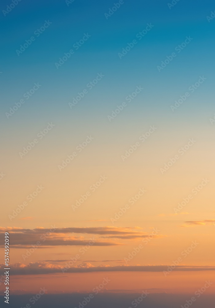 Naklejka premium Vibrant sunset sky with blue-orange gradient, minimal clouds below, clean background, high resolution, peaceful mood. 