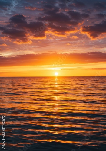 Fiery Orange Sunset Over Calm Ocean Water