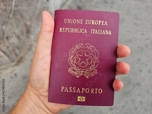 Close-Up of Hand Holding European Union Italian Passport – Travel and Identity Concept