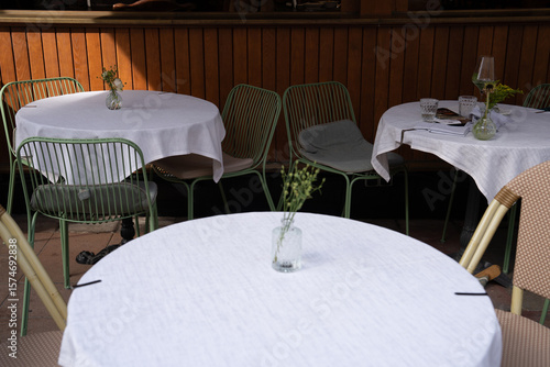 Charming Outdoor Caf Setting with Green Chairs