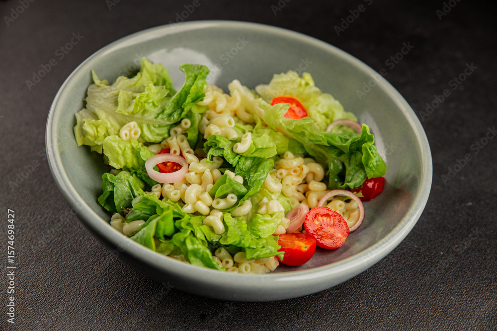 Pasta salad green leaf lettuce, tomato, pasta, onion fresh delicious gourmet food background on the table rustic food top view copy space keto and paleo diet vegan and vegetarian food Pasta salad green leaf lettuce, tomato, pasta, onion fresh delicious gourmet food background on the table rustic food top view copy space keto and paleo diet vegan and vegetarian food