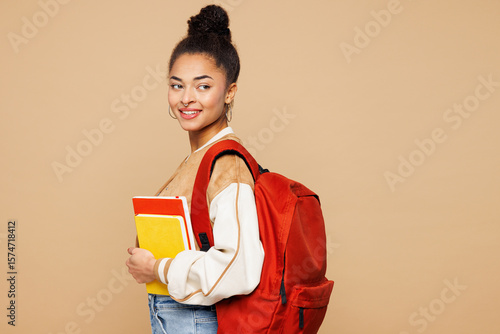 Foto Side profile view young smiling teen girl student wear casual clothes backpack b
