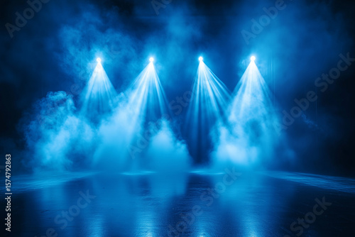 Dramatic stage lighting with blue spotlights illuminating smoke on a dark background