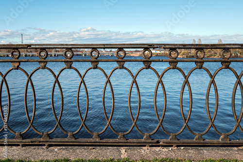 Decorative cast iron fence installed on the embankment in the city of Vyborg.
