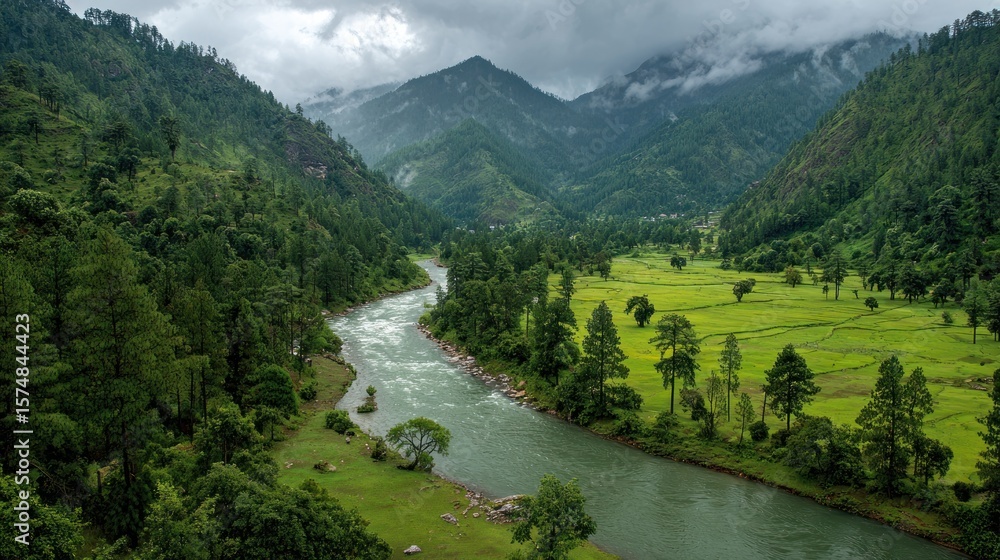 Serene river valley nestled between lush green mountains under a cloudy sky Serene river valley nestled between lush green mountains under a cloudy sky