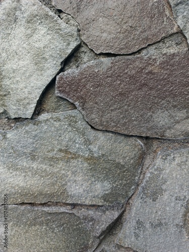 Abstract stone wall with multicolor flat rocks, excellent for construction template, industrial presentation, and urban texture design