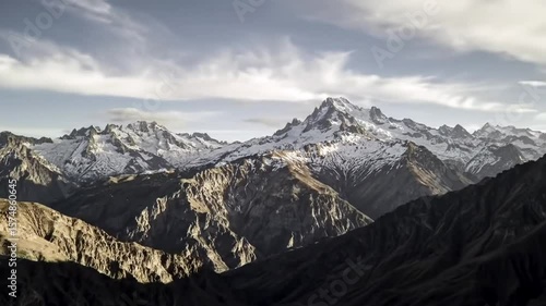 Snow-Capped Mountain Peaks under Dramatic Sky