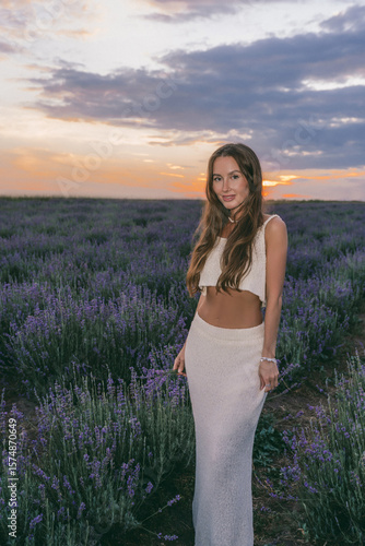 A Beautiful Woman Gracefully Posing in a Lavender Field During a Gorgeous Sunset