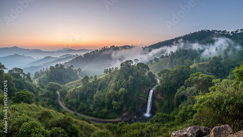 Panoramic dawn view of Haflong hills with terraced slopes, misty valleys, and a waterfall flowing through lush forests under a soft pastel sky—serene and high-definition.