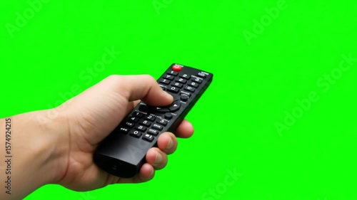 Hand Holding TV Remote with Green Screen Background 4K