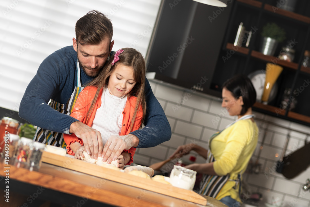 Fototapeta premium Dad carefully teaches his favorite little girl to knead.