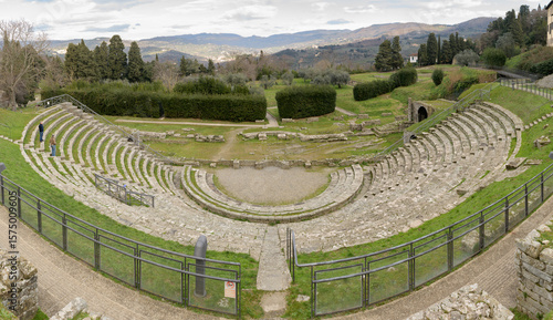 Ruins of the ancient Roman theater in Fiesole, near Florence, Italy, built in the 1st century BC, with semicircular seating and scenic backdrop.