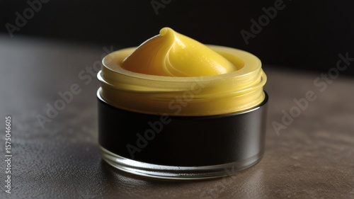 Luxurious Yellow Skincare Balm in Elegant Black Jar