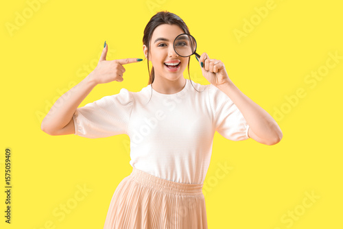 Young woman pointing at mag...