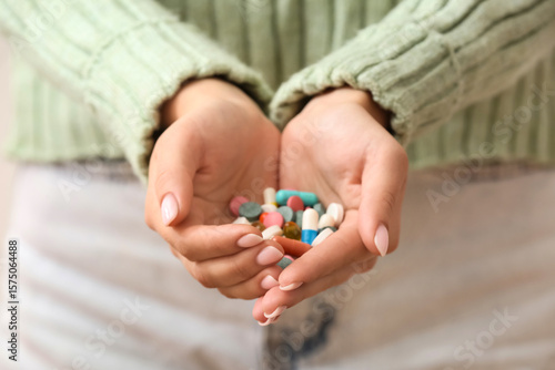 Woman holding different pil...
