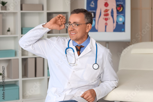 Smiling male doctor in whit...