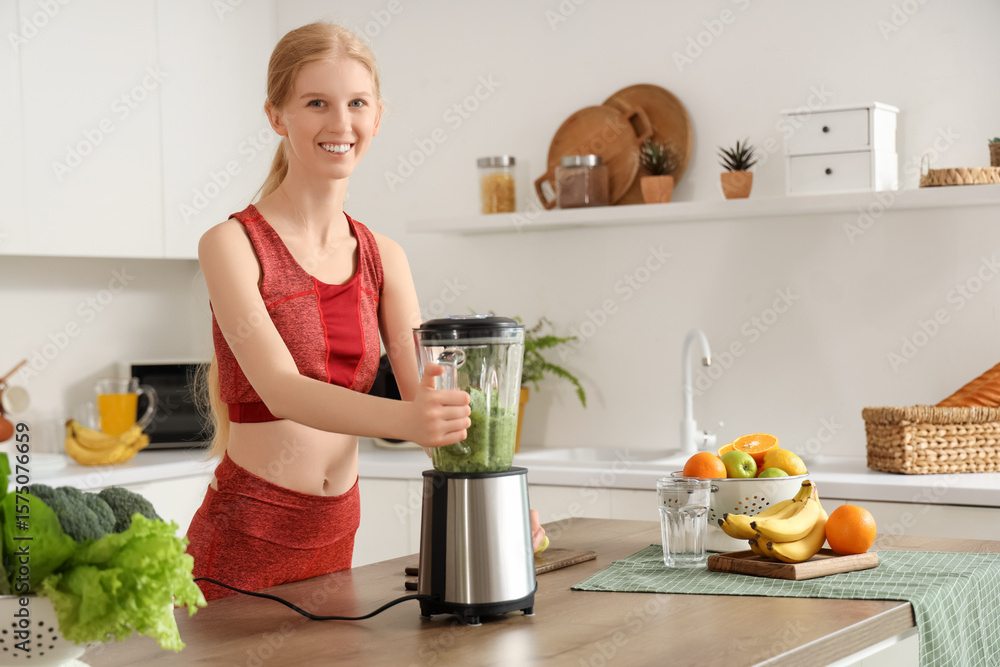 Happy sporty young woman with blender, fruits and vegetables making healthy smoothie in kitchen Happy sporty young woman with blender, fruits and vegetables making healthy smoothie in kitchen