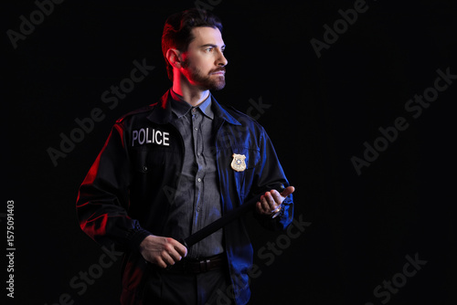 Male police officer with ba...
