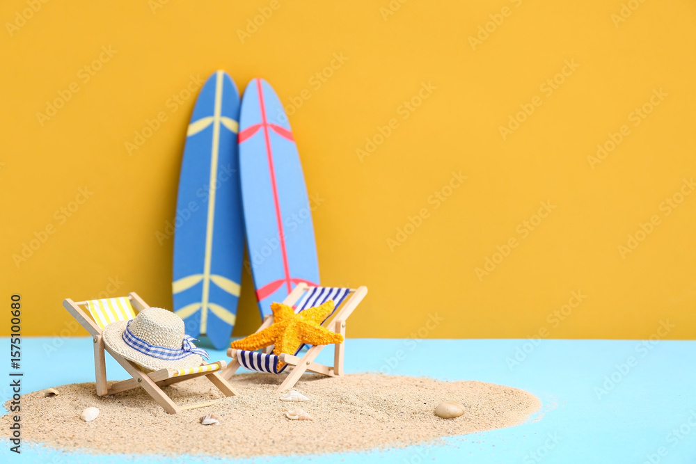 Starfish, sand, decorative deckchair, hat and surfboards on color background Starfish, sand, decorative deckchair, hat and surfboards on color background