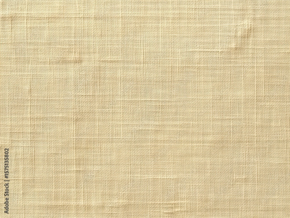 Fototapeta premium Close-up view of beige woven fabric texture with visible horizontal and vertical threads creating a grid pattern and subtle natural imperfections