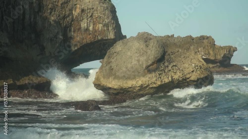 120 fps slow-motion shot of ocean waves crashing on sea rocks in Madasari Beach, Pangandaran, West Java, Indonesia.