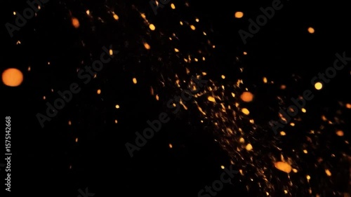 Dark background with suspended, scattered golden embers