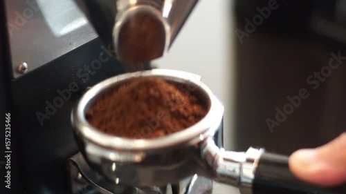 Barista fill the portafilter with coffee grounds to make espresso	