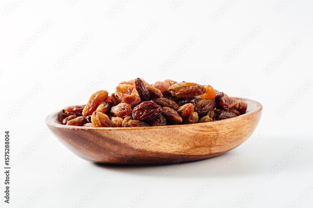 Obraz premium Healthy Dried Fruits on Wooden Bowl Isolated on White Background