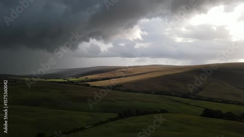 Dramatic Stormscape: Rolling Hills Under Ominous Clouds