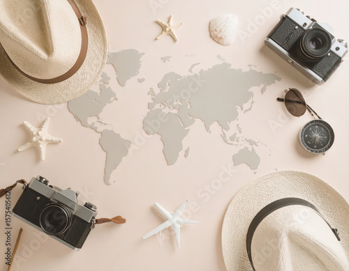 Close up photography of a map with other holiday gear is placed on a table.