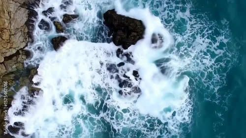 Wallpaper Mural Aerial View of Ocean Waves Crashing Against Rocky Coastline with White Foam and Turquoise Water Torontodigital.ca