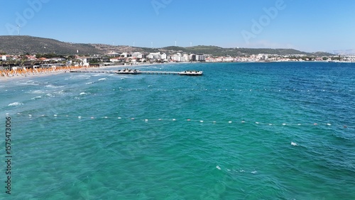 Fototapeta Naklejka Na Ścianę i Meble -  Aerial view of a scenic pier stretching into the turquoise sea