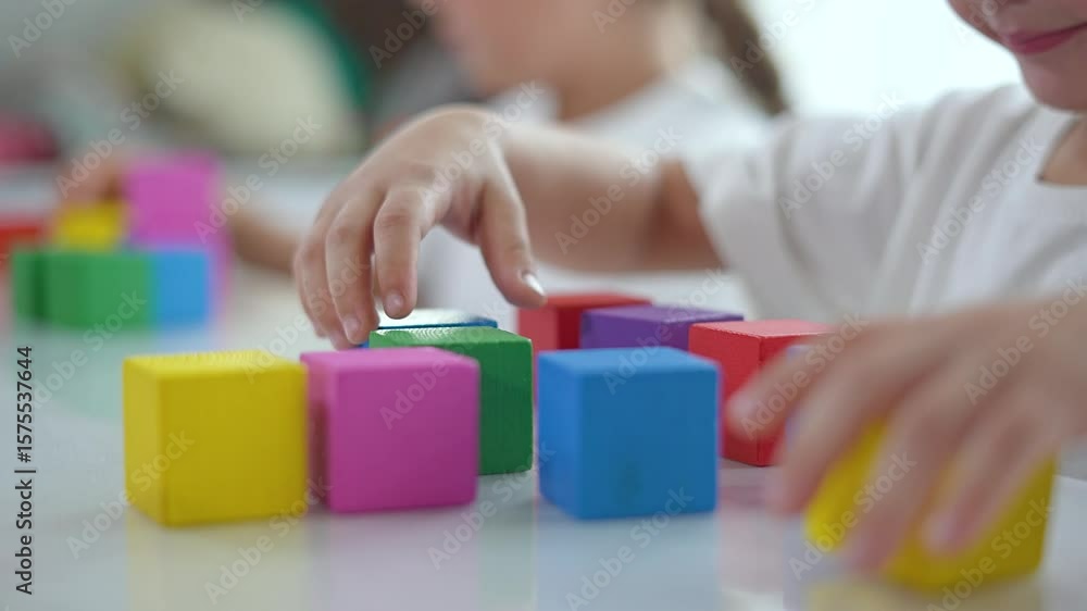 Sister brother play with blocks at home. Sister and brother enjoy building block towers. bonding time with blocks indoors. Home activities as sister and brother play. Blocks bring family fun at home.