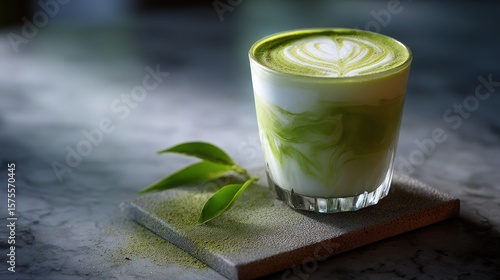 Green Matcha Latte with Milk Foam in Glass Cup