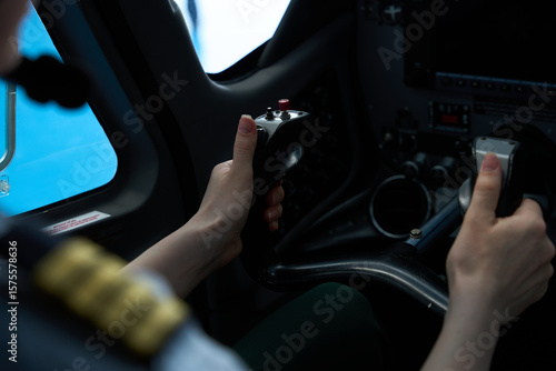 Fotomural Pilot student operating aircraft controls during flight training