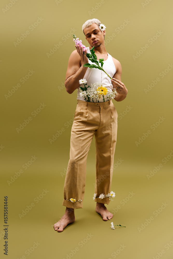 Fototapeta premium Young man with dyed hair and flowers showcasing fashion in a vibrant studio setting