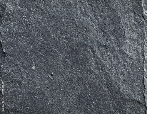 A black stone texture forms a rough and natural background