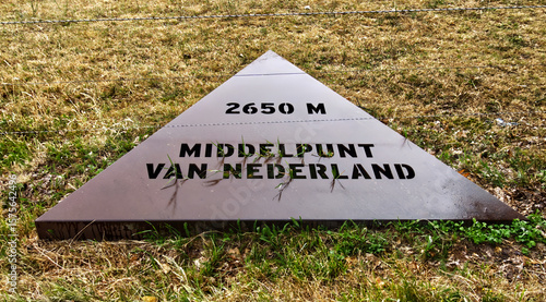 Photography Metal triangular sign indicating the geographic center of netherlands with altit