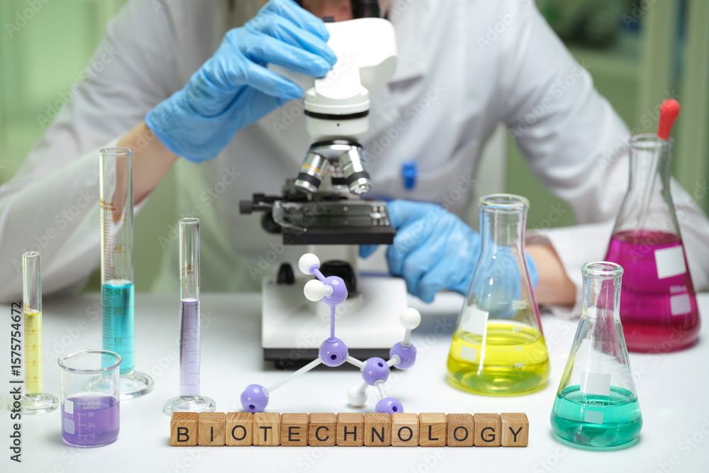 Fototapeta premium A meticulous scientist carefully examines various samples under an advanced microscope in a thriving biotech lab