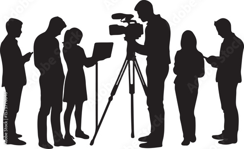 Silhouetted people gathered around a camera operator and laptop group gathering