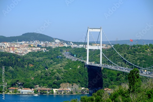 Fatih Sultan Mehmet Bridge, the second bridge across the Bosphorus. Bridge pier. Traffic flow on the bridge. Fatih Sultan Mehmet Bridge with trees. Tourism destination. Istanbul - Turkey.