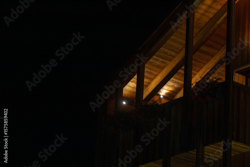 Beautifully Illuminated Wooden Building Facade Captured During a Tranquil Night Scene