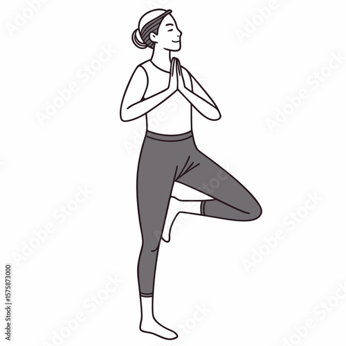 Woman performing tree pose with eyes closed and hands pressed together yoga vrikshasana