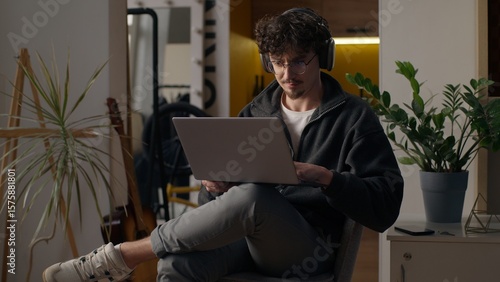 Photography Focused Hispanic guy hipster user holding laptop purchasing delivery at home fre