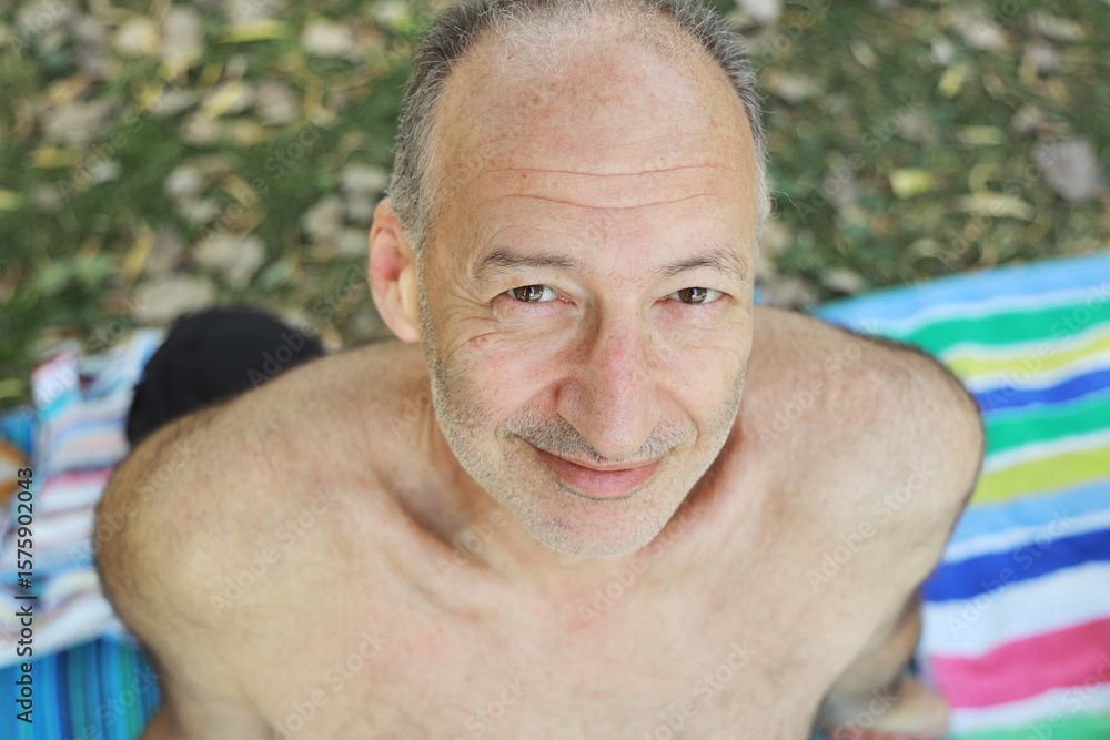 Obraz premium man on the beach, rest, vacation, portrait of a man, sunbathing, on the lake, vacation on the river, summer vacation, good mood, man on the beach, smile 